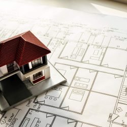 Detailed model of a luxury house on architectural blueprints.