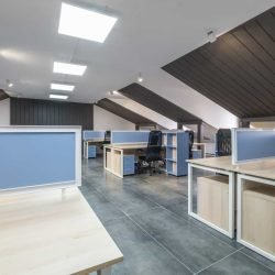 Office workspace with desks, chairs, and modern design elements for professional environments.